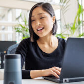 Female professional using virtual assistant at desk