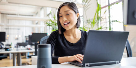 Female professional using virtual assistant at desk